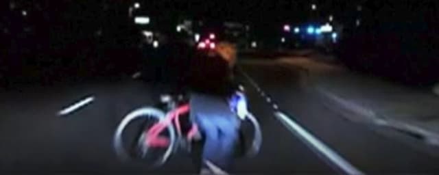 From the dashcam video, Elaine Hertzberg looks up too late as she tries to walk her bike across Mill Ave. in Tempe, Ariz., before sheis struck and killed by an Uber self-driving car. (Image courtesy of Arizona police.)